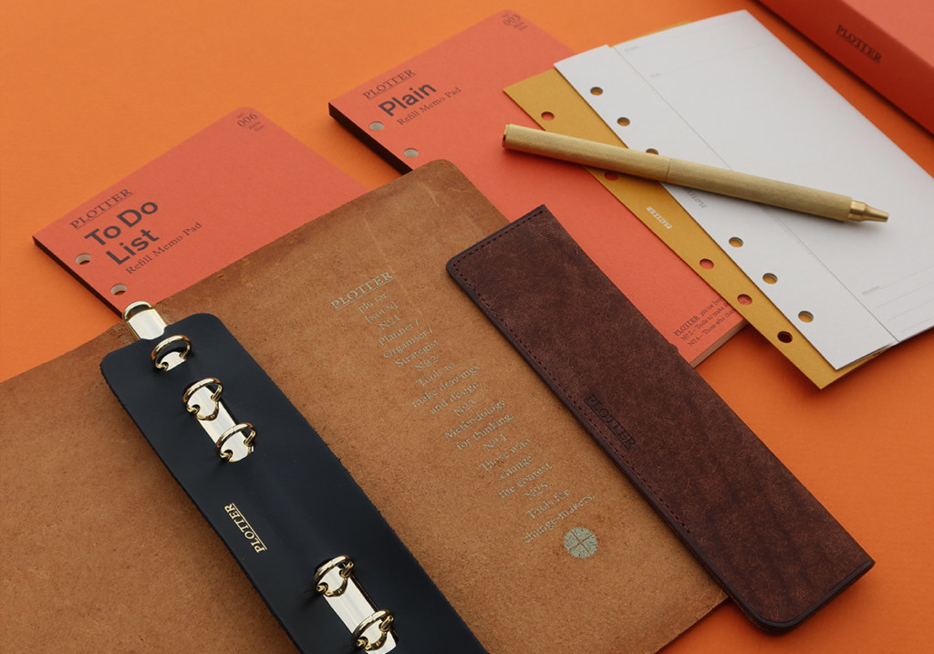 A PLOTTER Leather Binder opened on top of different PLOTTER Refill Memo Pads.