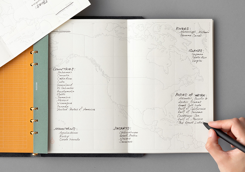 A person labeling a Map in a PLOTTER Leather Binder.