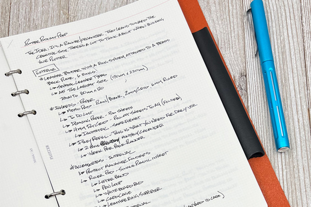 Close-up of brainstorming notes on PLOTTER 2mm Grid Refill for A5 Size.