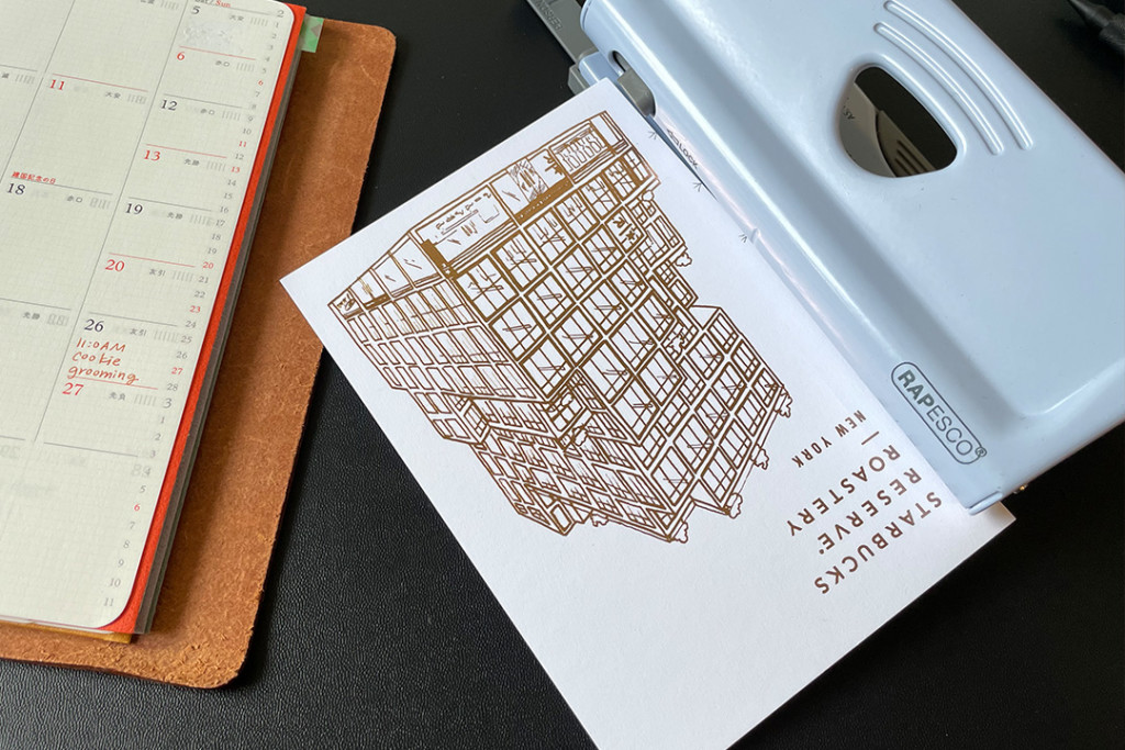 Hole punching a postcard to fit in a PLOTTER leather binder in Bible Size.