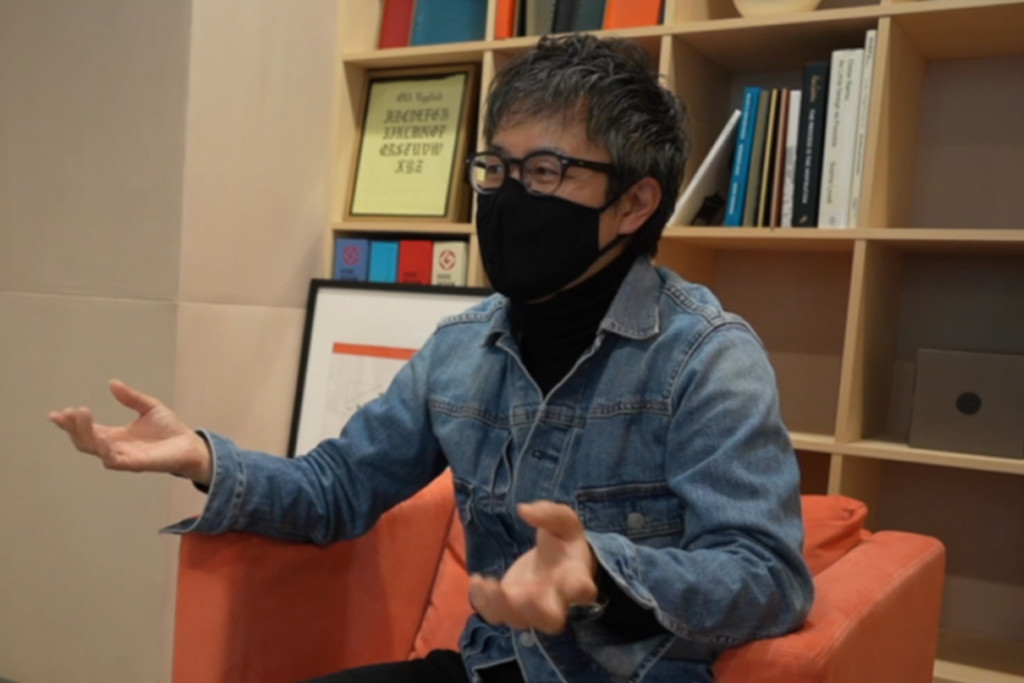 PLOTTER director Takayuki Saito gesturing.