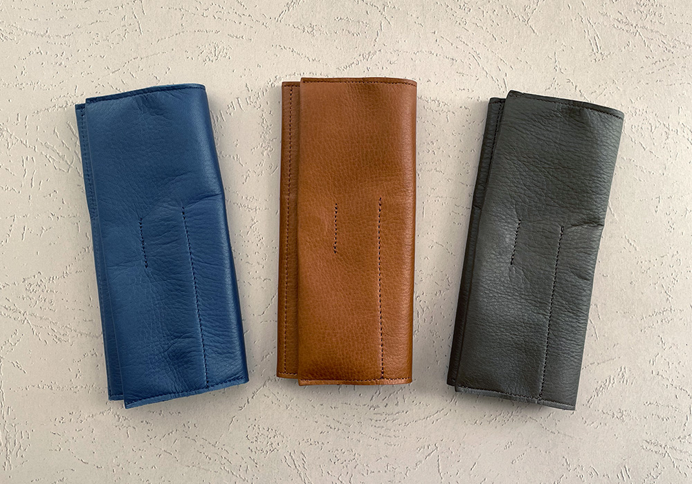 PLOTTER roll pen case in three colors: navy, brown, and gray.