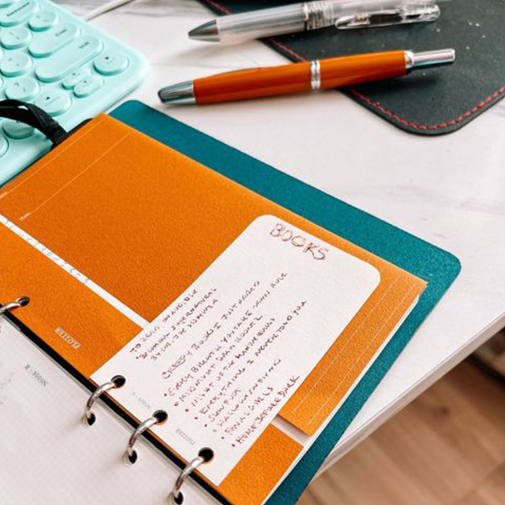 Layering a Card Size Refill with small notes on a Project Manager inside a PLOTTER.