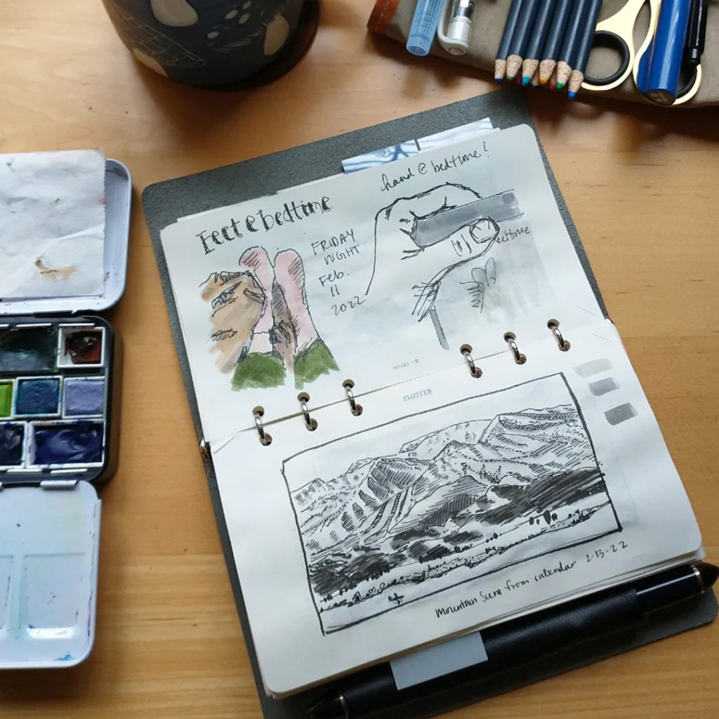 An open PLOTTER in Bible Size with drawings of a hand, a pair of feet, and a mountain scene.