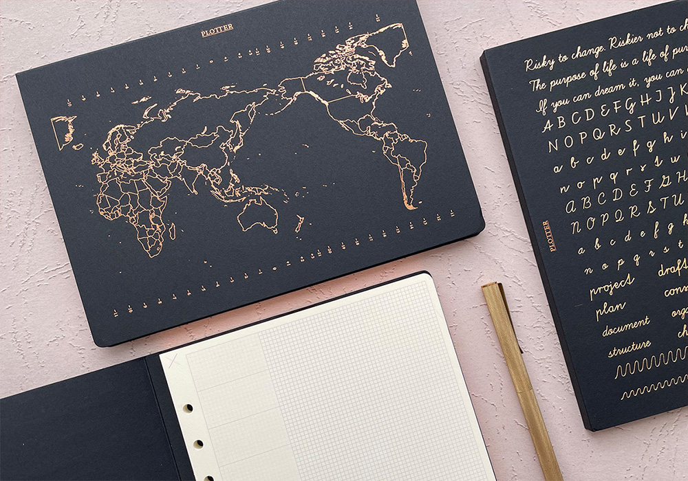 Three PLOTTER Limited Notepad with foil stamping next to each other.