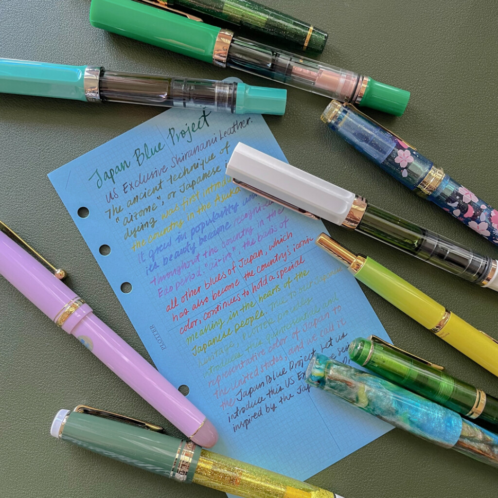 A Blue Paper Refill by PLOTTER with writing samples from a variety of different ink colors.