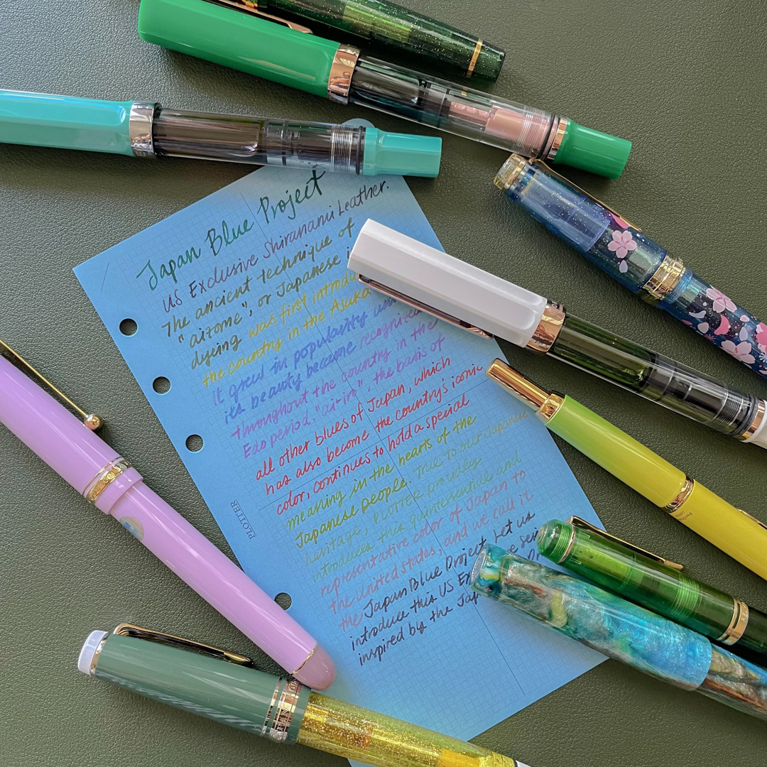 A Blue Paper Refill by PLOTTER with writing samples from a variety of different ink colors.