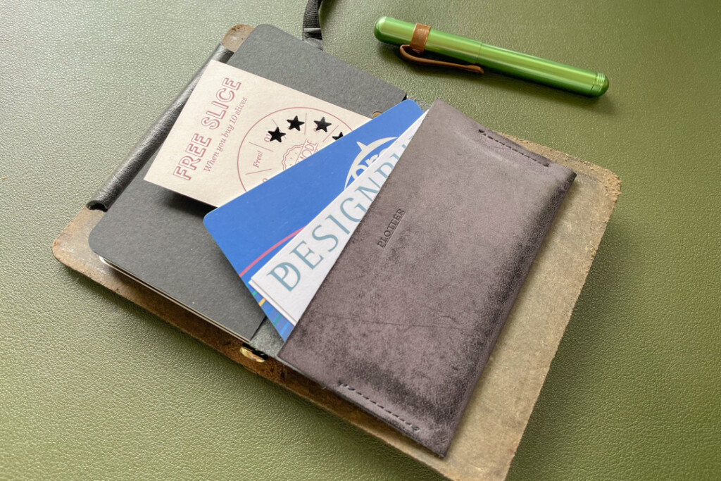 A PLOTTER in Mini 5 Size holding a variety of cards in the wallet card holder.