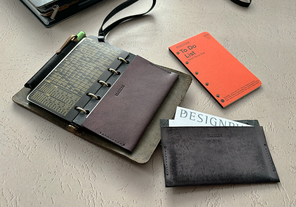 PLOTTER Limited Purple Leather Card Case inside the Mini 5 Leather Binder next to a To Do List Refill Memo Pad and Leather Card Case.