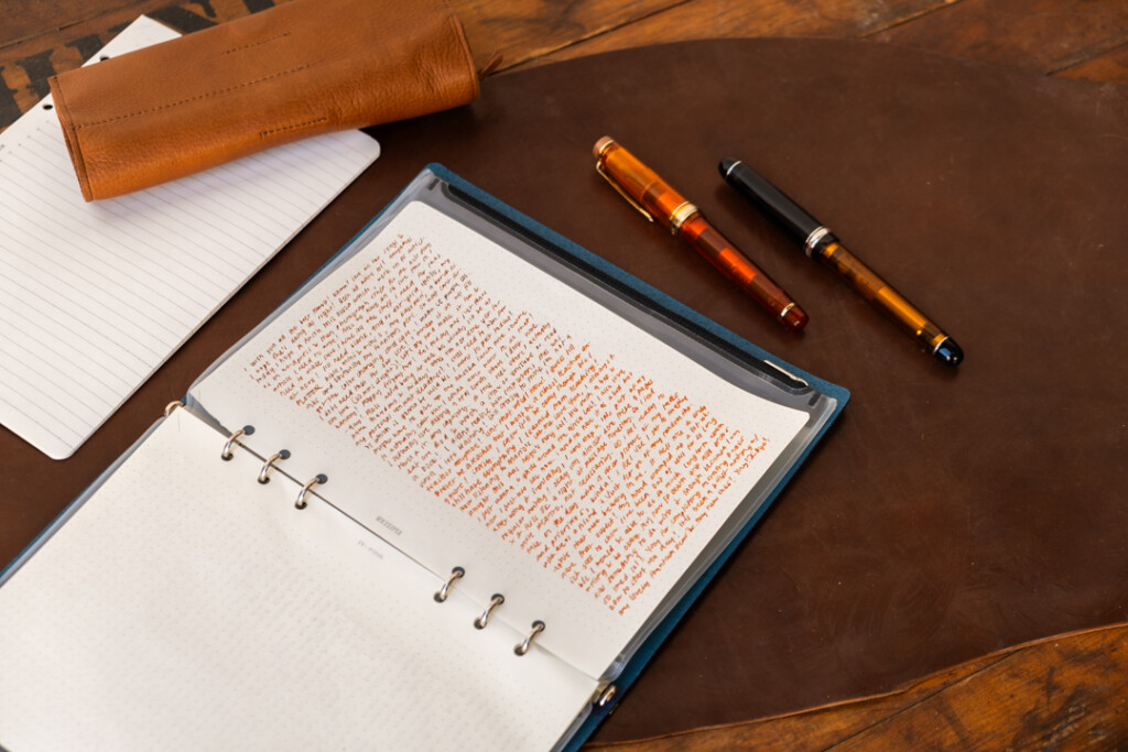 A PLOTTER Leather Binder in A5 Size with a page filled with stream of conscious writing.