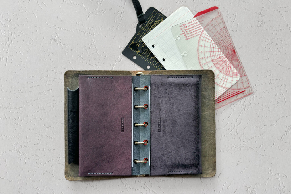 A side by side comparison of a Limited Edition Purple Leather Card Case with the original PLOTTER Leather Card Case. 