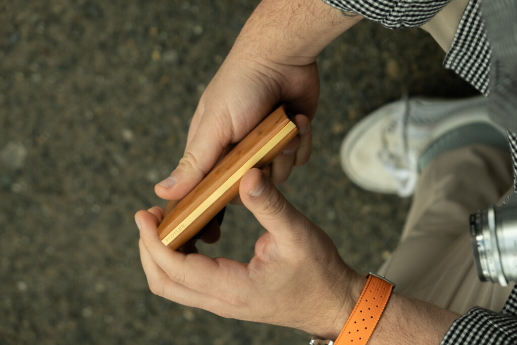 Chris Giannakos holding his PLOTTER Leather Binder Mini 5 in Pueblo Beige leather.