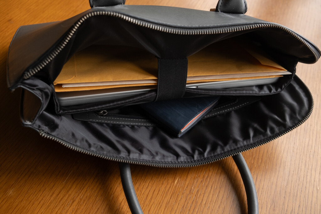 A PLOTTER Horse Hair II Narrow Size Leather Binder inside a leather briefcase.