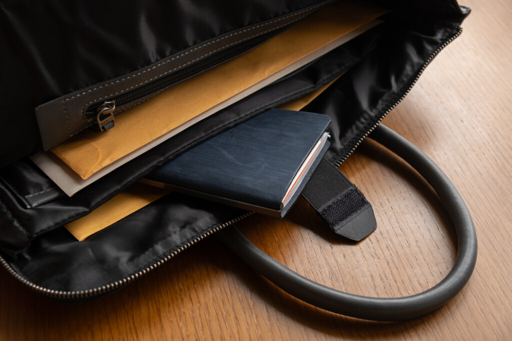 A PLOTTER Horse Hair II Narrow Size Leather Binder inside a leather briefcase.