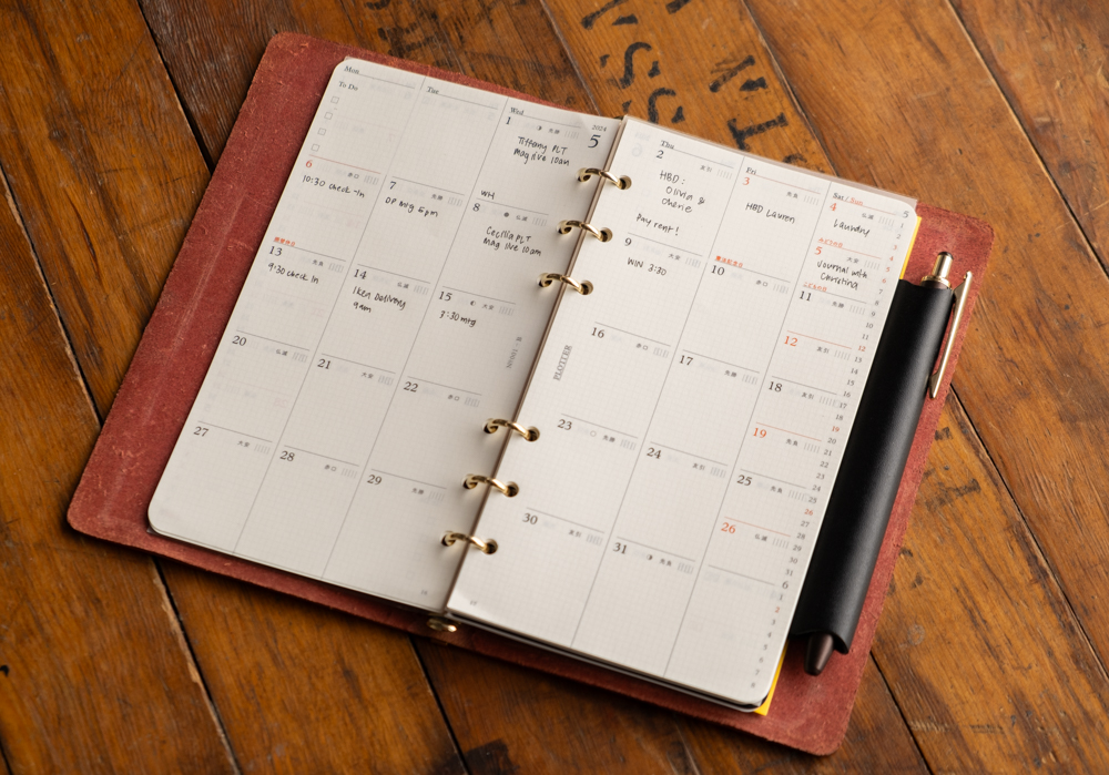 Monthly calendar inside a PLOTTER leather binder.