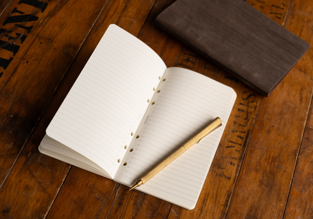 6 mm Lined Paper Refill Memo Pad with brass pen on top of it.