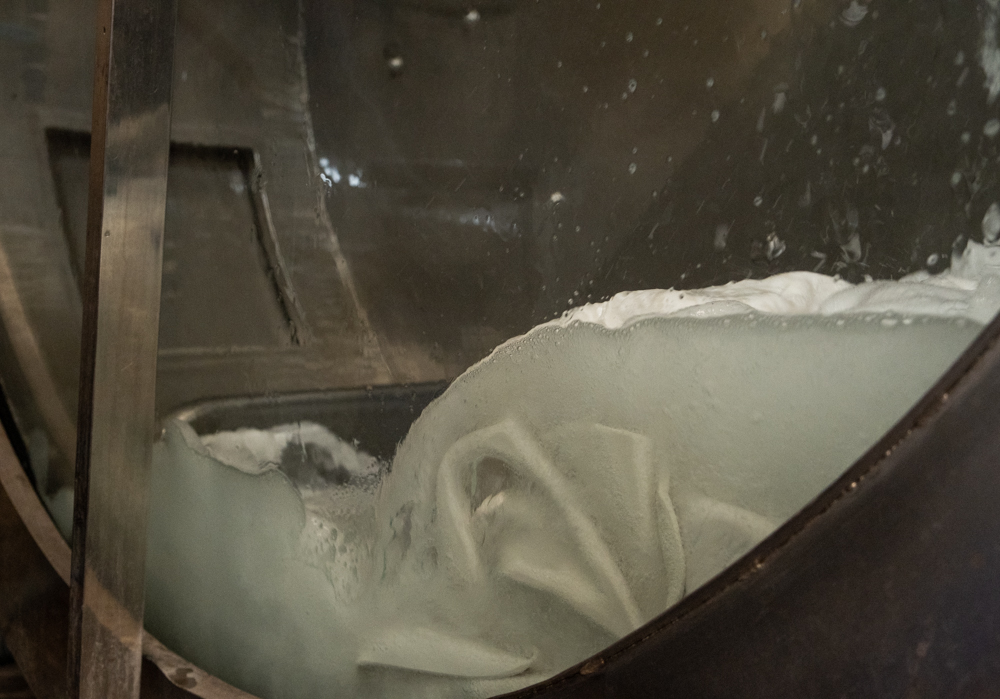 White leather in a spinning dyeing drum with a tanning solution.