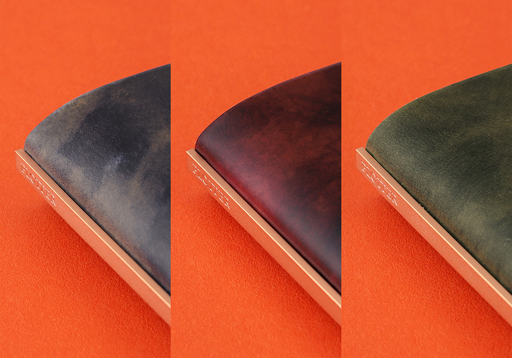 Leather Binder in Unevenly Dyed Cordovan in Blue, Wine, and Green.