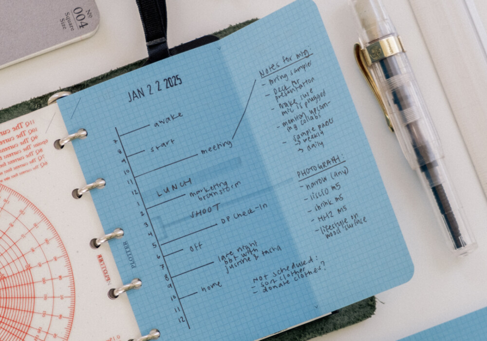 Mini 5 Square refills in Blue Paper unfolded to show that it extends past the PLOTTER Mini 5 Leather Binder, allowing more room to draw a vertical daily schedule.