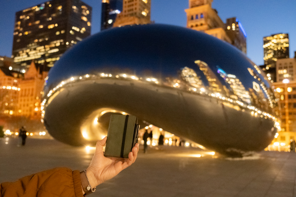 A person holding a PLOTTER Mini 5 in front of The Bean in downtown Chicago!