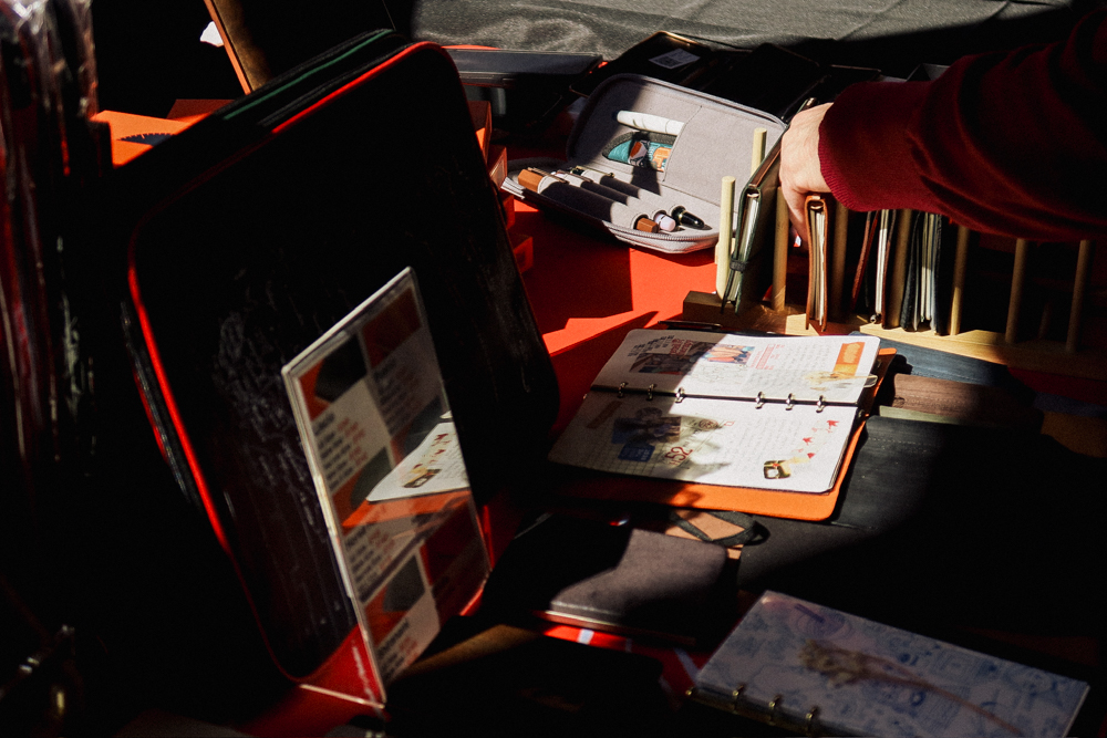 Person shopping at the PLOTTER USA table at Chicago Stationery Fest 2025.