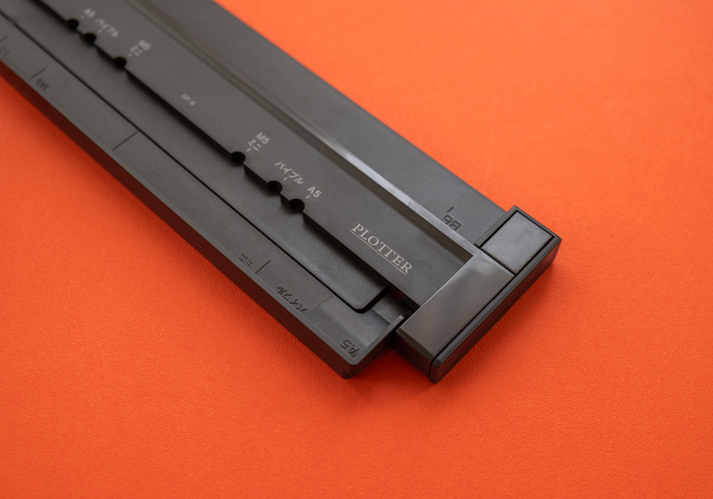 The gauge section of the CARL Refill Maker Hole Punch with a PLOTTER Logo.