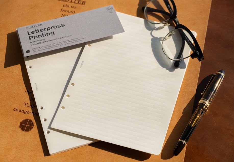 The PLOTTER Letterpress Printing refill in A5 Size on a leather mat.