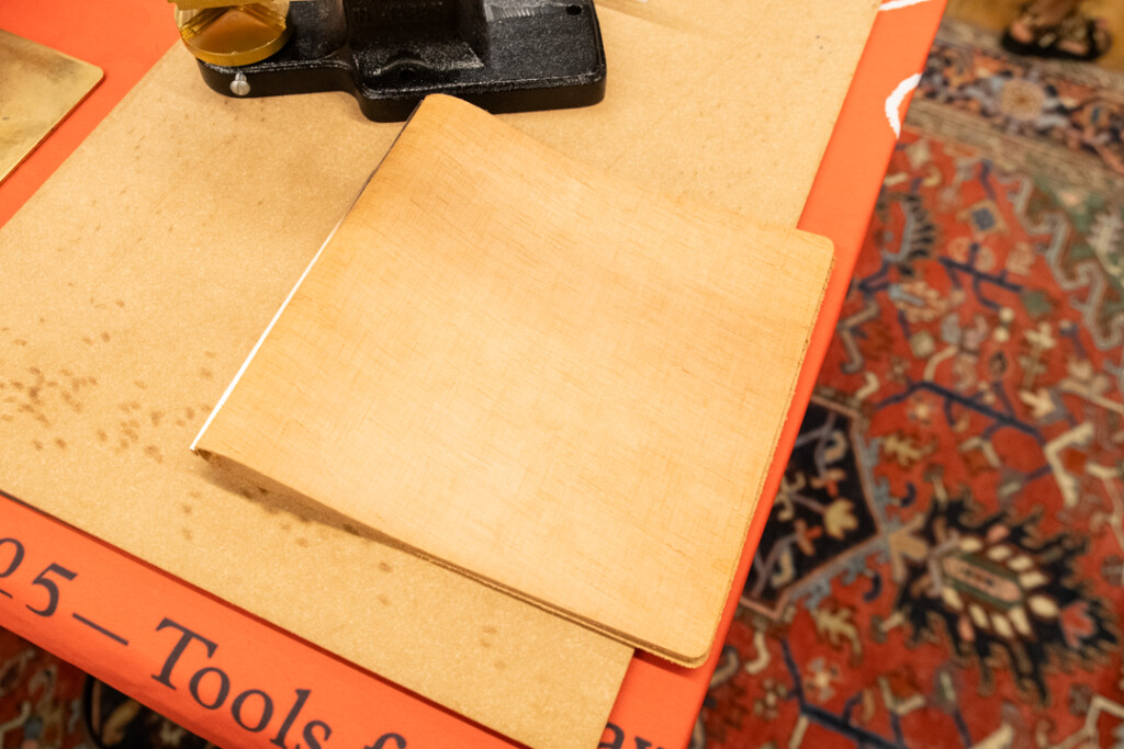 A PLOTTER Leather Binder in Bible Square size on the PLOTTER table at the Atlas Stationers sidewalk sale.