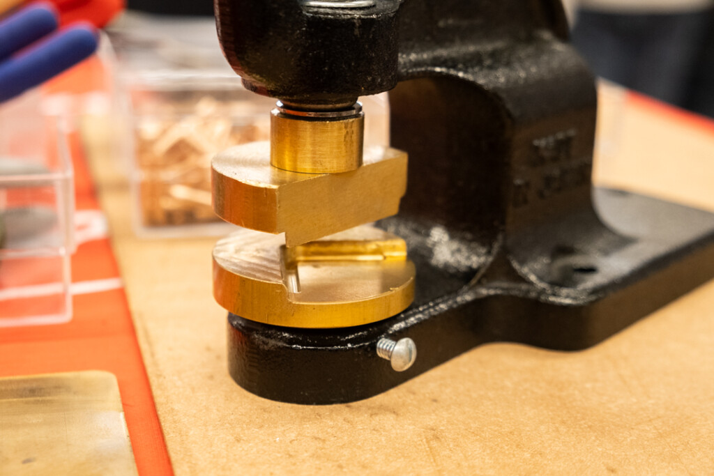 The PLOTTER corner rounder customization machine on top of a leather mat.
