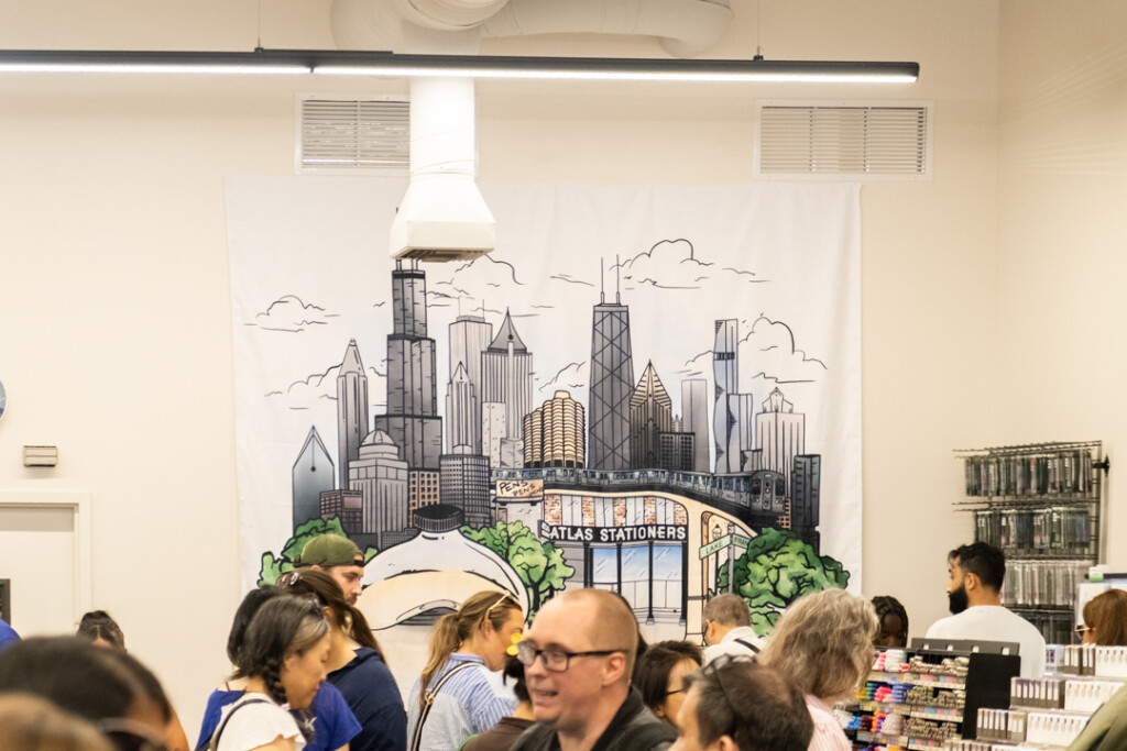 The interior of the Atlas Stationers store filled with people shopping during their sidewalk sale.