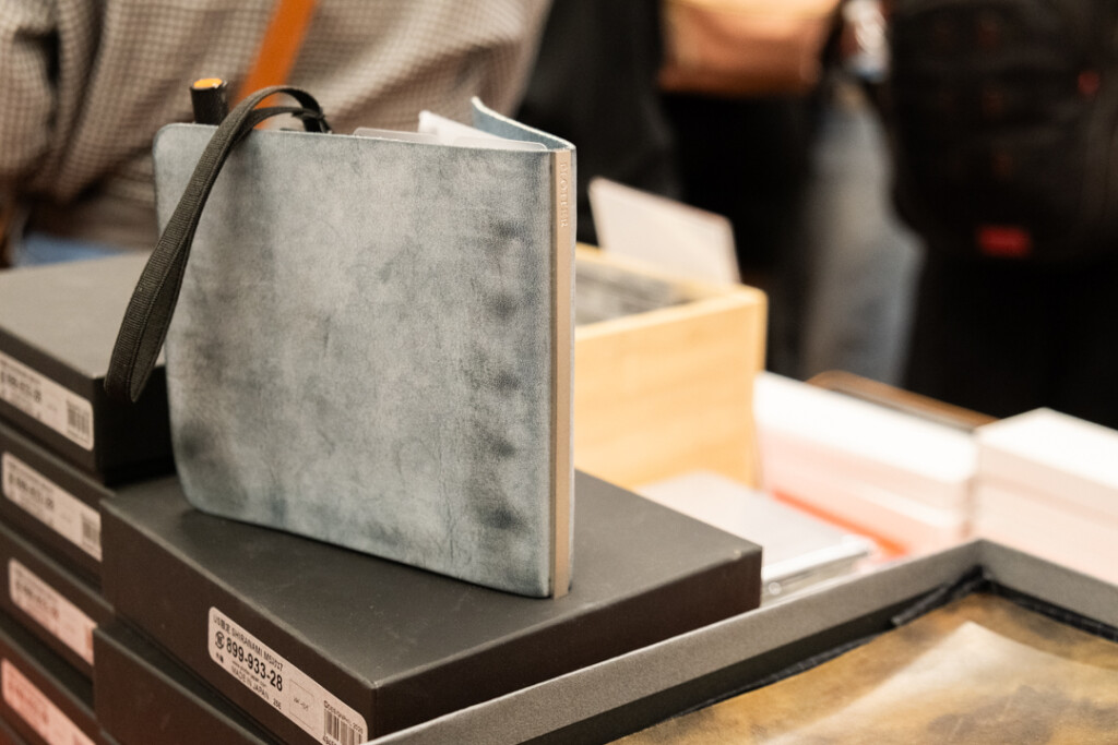 PLOTTER Leather Binder in Shiranami Square Size on the PLOTTER table at the Atlas Stationers Sidewalk Sale.