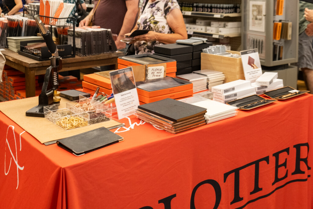 The PLOTTER USA table at the Atlas Sidewalk sale filled with PLOTTER products.