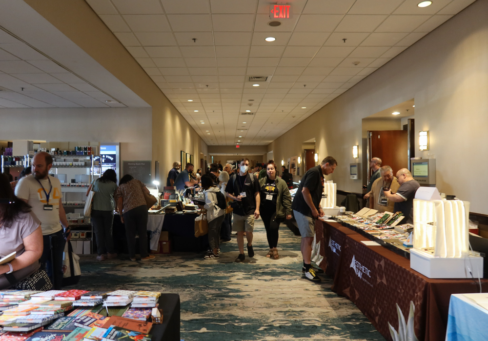 A crowd of attendees and customers shopping at the SF Pen Show.