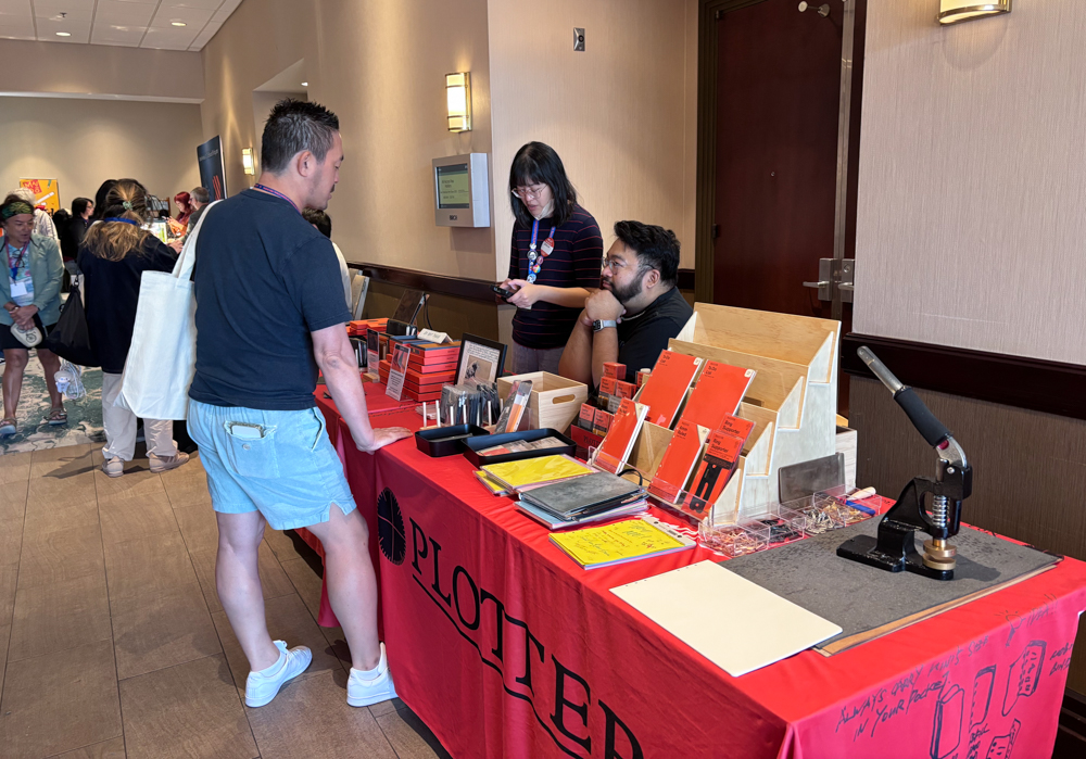 A customer shopping at the PLOTTER USA table at the SF Pen Show.