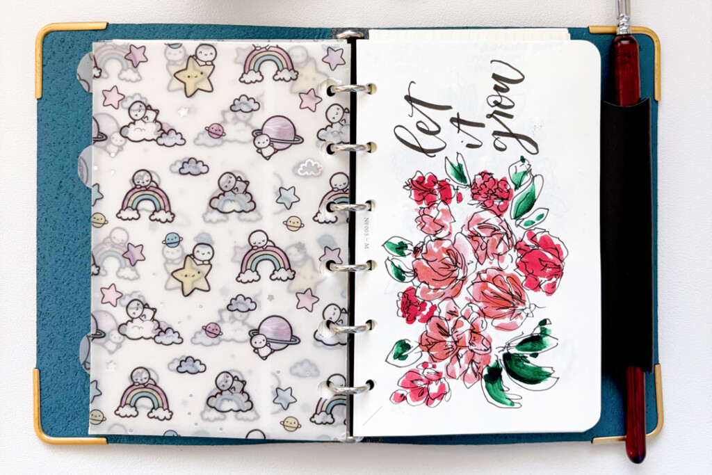 PLOTTER Leather Binder in Mini Size opened to a page with abstract floral drawings, which were drawn with fountain pen ink.