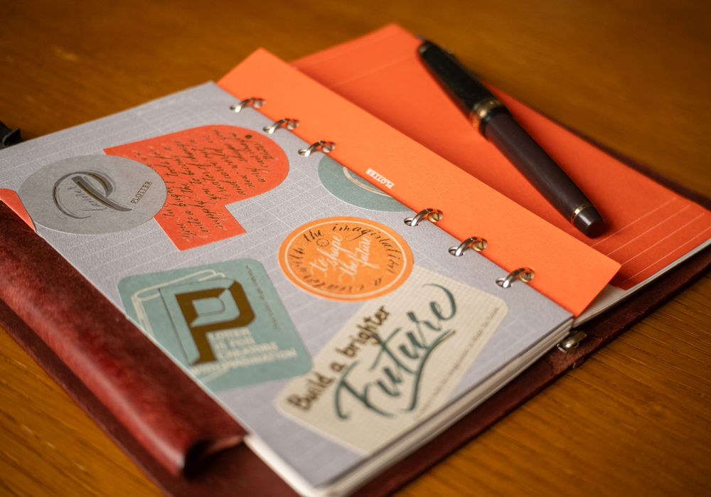 Bible Size PLOTTER Leather Binders open to a decorated project manager folder.