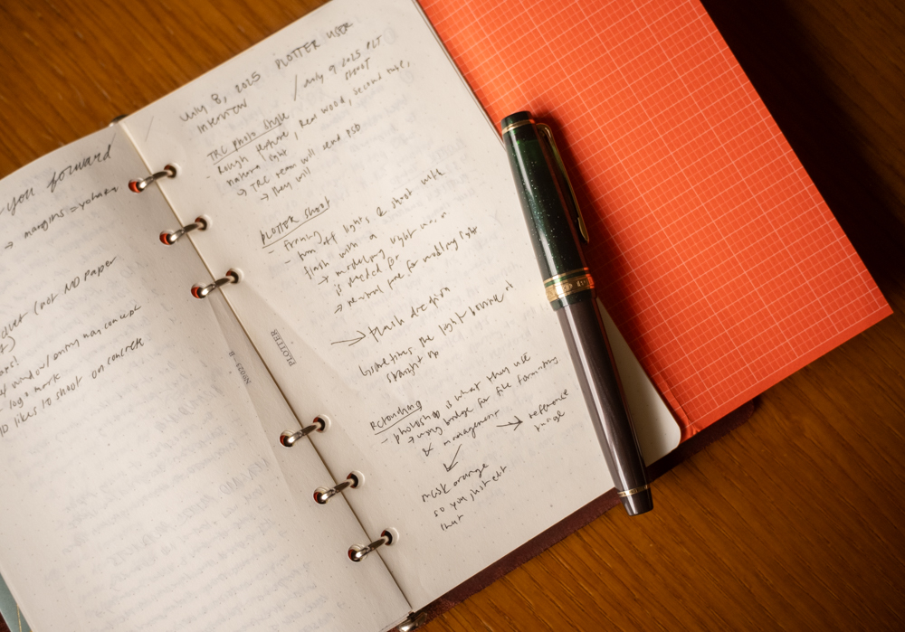 A PLOTTER Leather Binder in Bible Size open to a page full of notes.