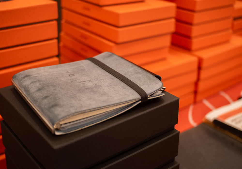 A close-up of the PLOTTER USA table showcasing the PLOTTER USA-exclusive Shiranami leather binders.