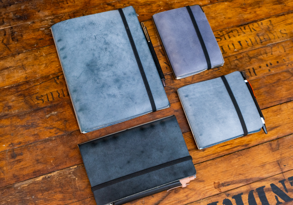 Four different sizes of US Exclusive Shiranami Leather Binders next to each other.