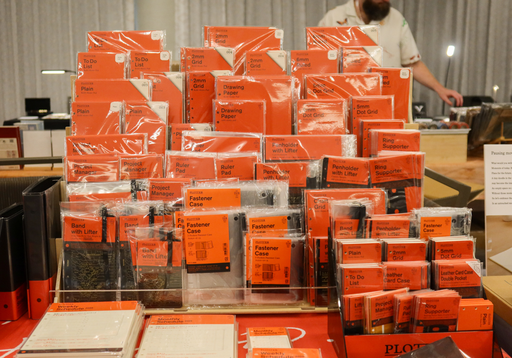 The large wooden display filled with PLOTTER refill memo pads and accessories.