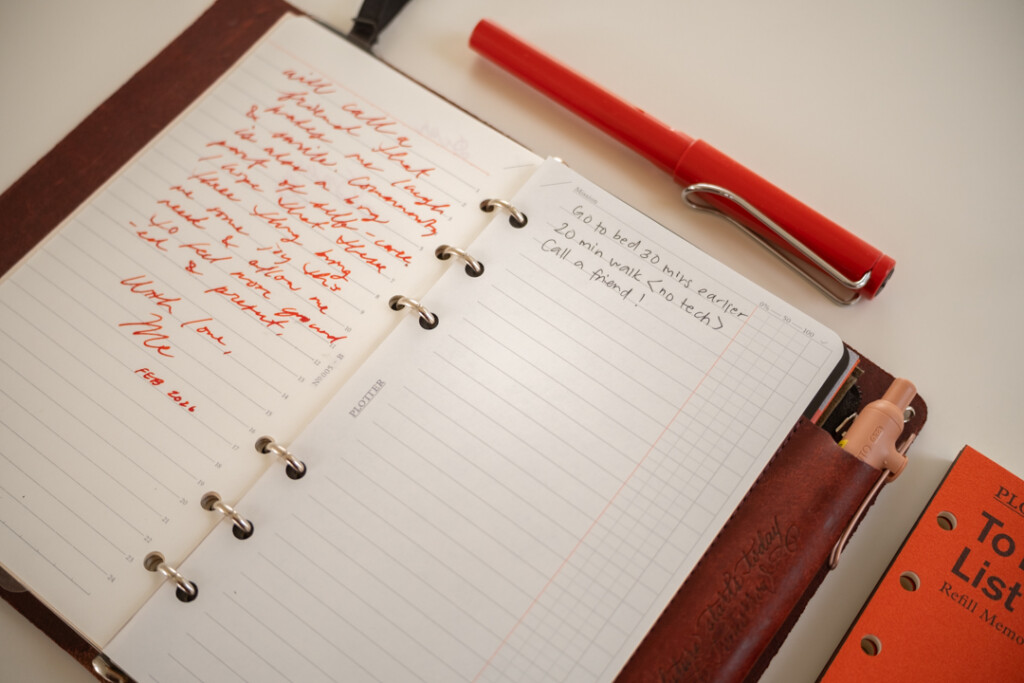 A PLOTTER Leather Binder open to a self-care to-do list, and that binder is beside a PLOTTER Refill Memo Pad and fountain pen.