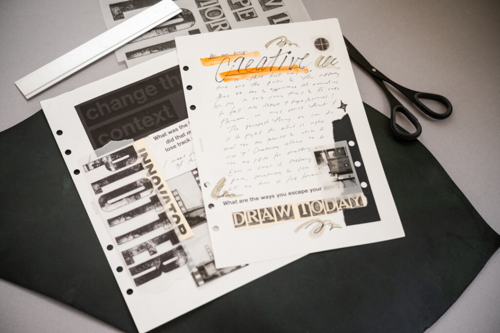 Two separate collages on white paper with black and white graphics and pictures, which is on top of a leather mat and a grey table.