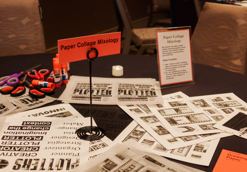 A round table with a black tablecloth with different collage materials, papers, and ephemera on it.