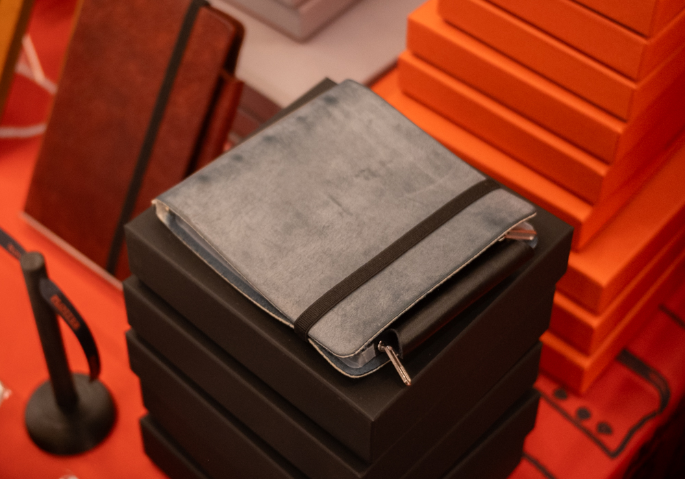 Square leather binder on the PLOTTER USA table.