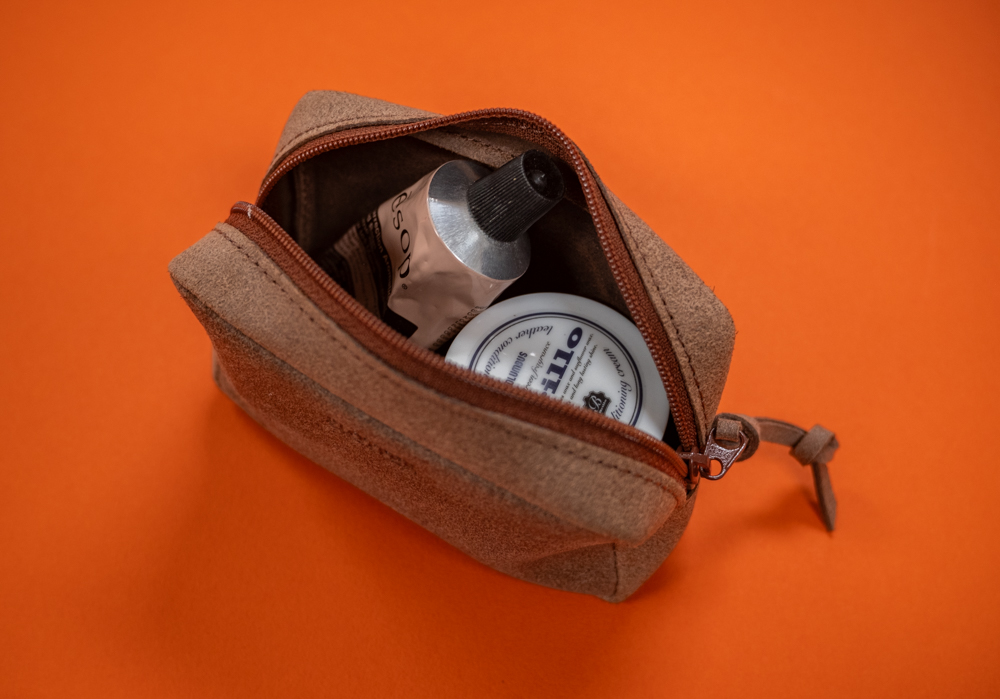 Gusseted pouch featuring split leather holds small accessories.