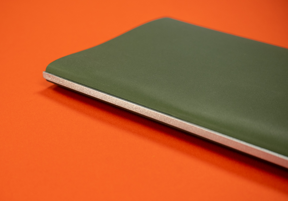 Roots leather binders feature a silver backplate.