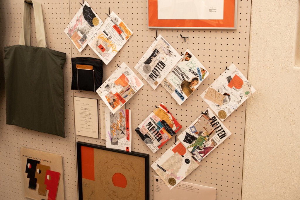 A peg board filled with collages created on PLOTTER Drawing Paper which relate to creativity and use a mixed media approach, which incorporates torn paper, stamps, and calligraphy lettering.