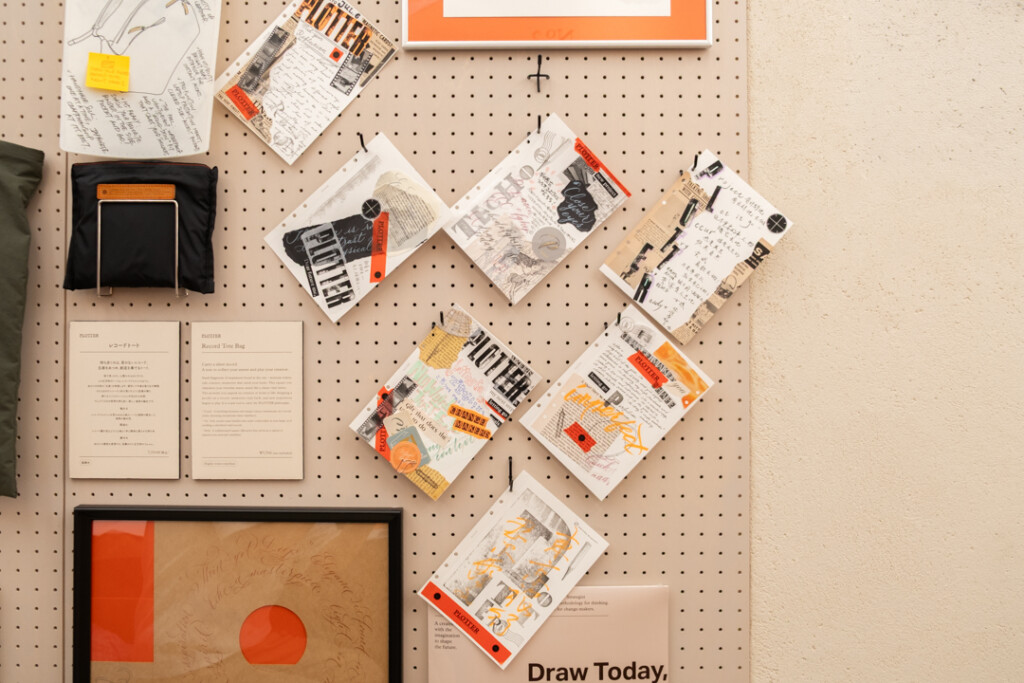 A peg board filled with collages created on PLOTTER Drawing Paper which relate to creativity and use a mixed media approach, which incorporates torn paper, stamps, and calligraphy lettering.