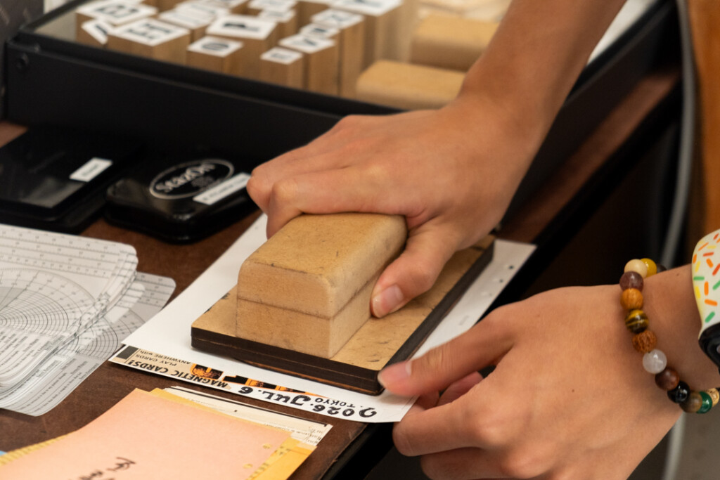 A person using a large wooden stamp.