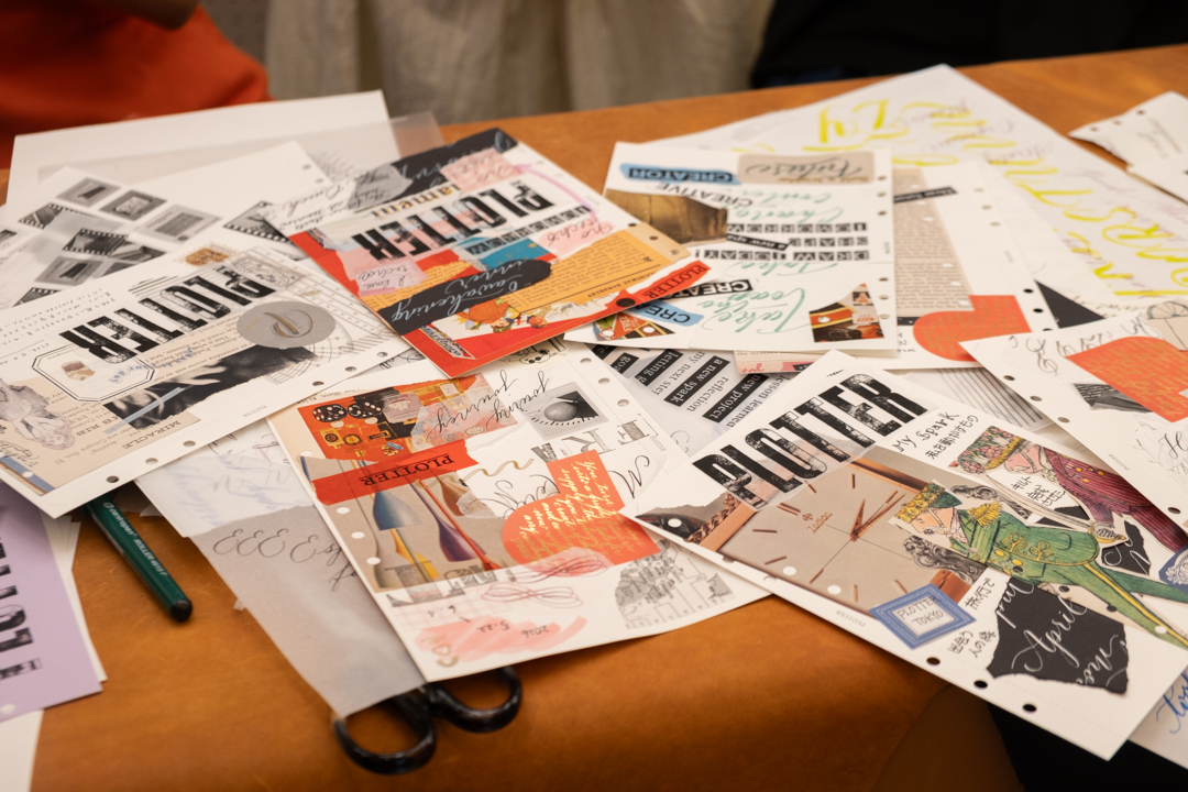 A table filled with collages on PLOTTER Drawing Paper which relate to creativity and use a mixed media approach, which incorporates torn paper, stamps and calligraphy lettering.